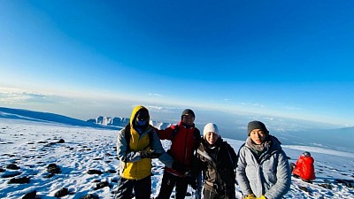 Uhuru peak with senior gibee the guide kilimanjaro